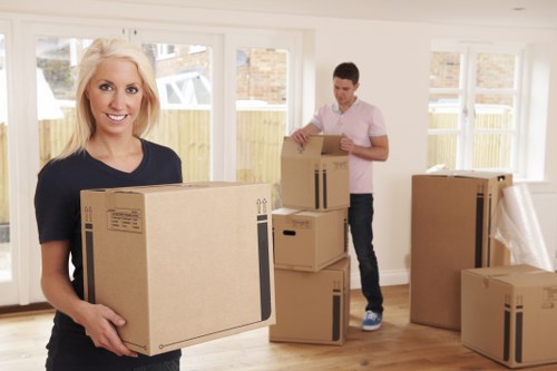 Professional movers handling furniture in a Cockfosters street